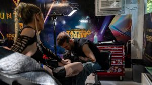Getting a tattoo at UNTOLD 2026 - imagine reprezentativă
